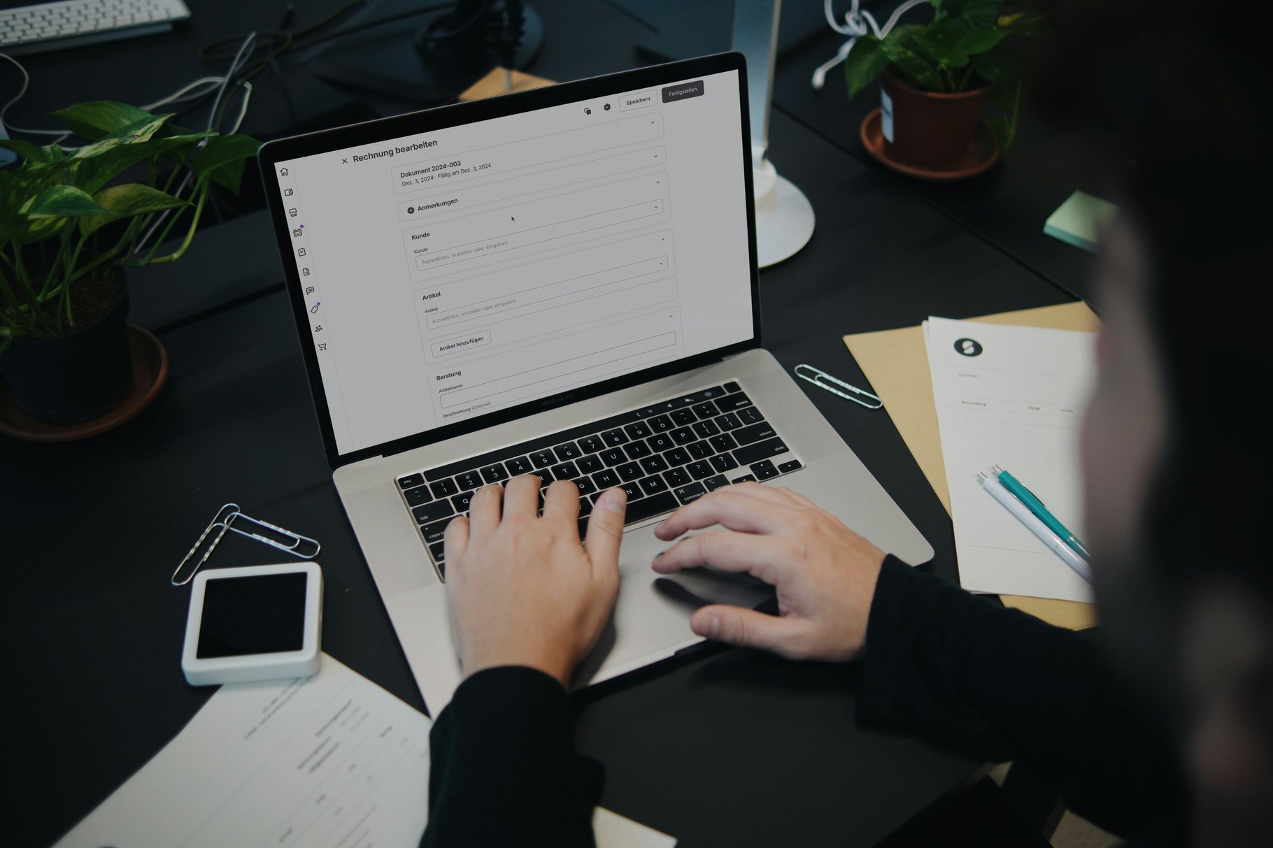 Hands typing at a laptop while a document form is completed on screen